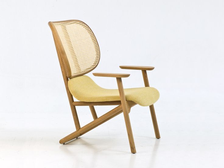 The Klara is a wooden armchair with a simple, linear style .