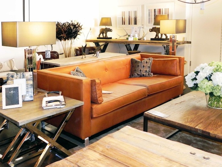 This burnt orange leather sofa is the essence of casual chic .