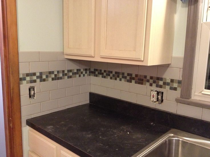 Subway tile backsplash with glass tile accent, love my kitchen .