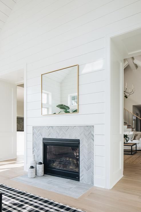 Cottage living room designed with a shiplap fireplace wall tiled .
