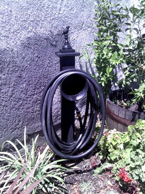 Diy garden hose holder made from scrap wood, dollar tree pot and .