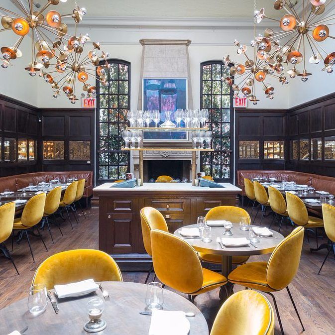 Mustard yellow Beetle Chairs adorn the lavish dining room at .