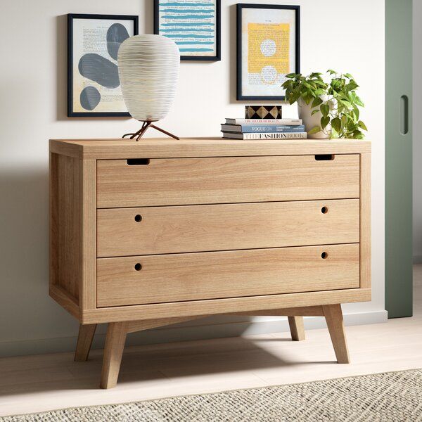 This three-drawer dresser showcases a Scandinavian-inspired look .