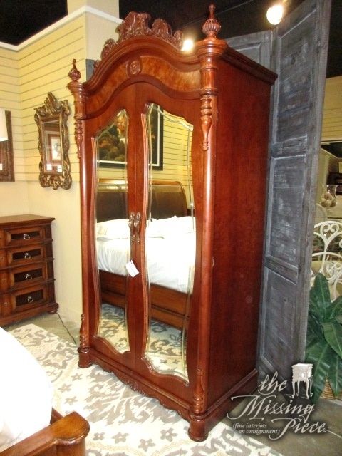 Stunning traditional style Pulaski armoire in a rich medium finish .