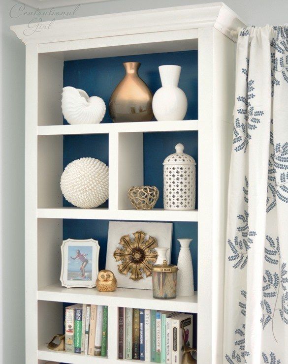 Top a basic bookshelf with crown molding to make it look built-in .