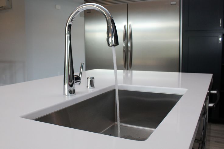 White quartz counter with stainless steel undermount sink and .