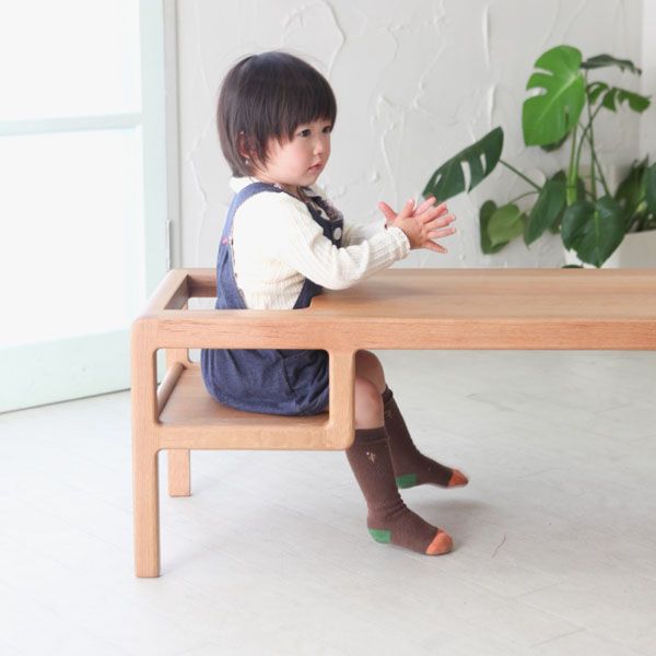 A table with built-in baby seat by Toa Ring