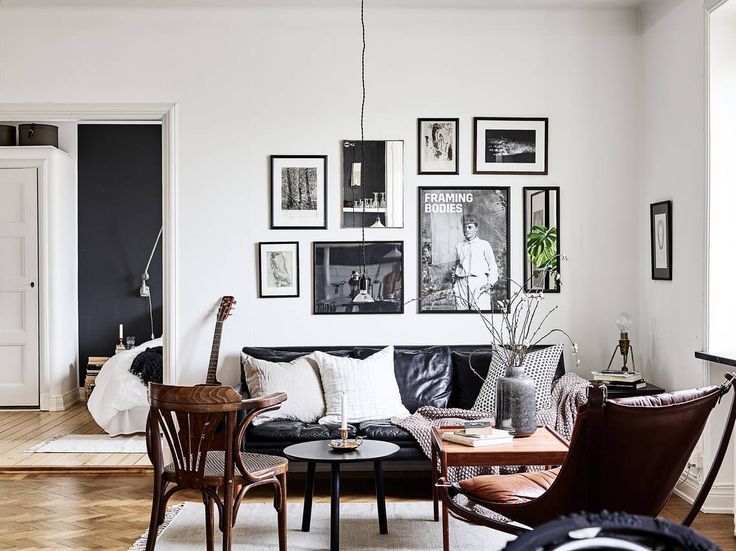 Cozy hipster living room with black leather sofa | Black sofa .