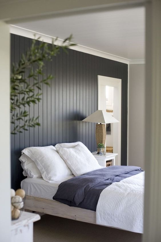 The dark painted wood paneling feature wall makes quite a .