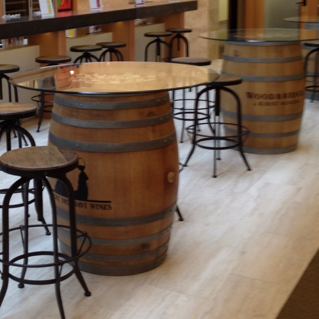 Wine barrel cocktail tables in the office. Love this idea wine .