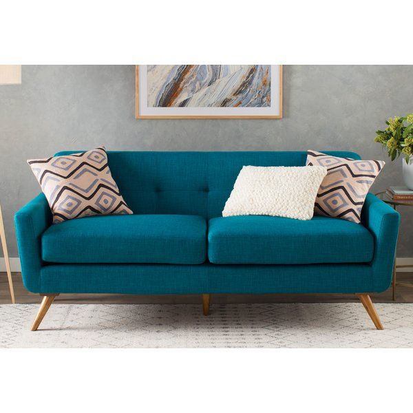 Defined by subtly button-tufted upholstery, splayed legs, and a .