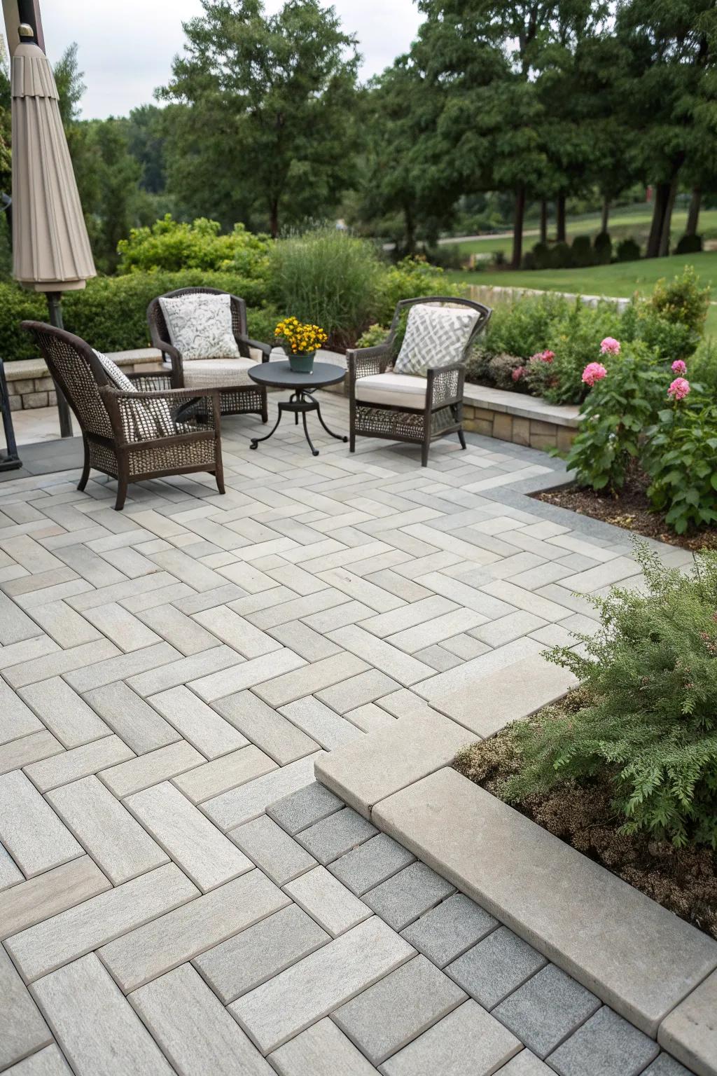 Herringbone pattern with concrete pavers for a stylish patio look.
