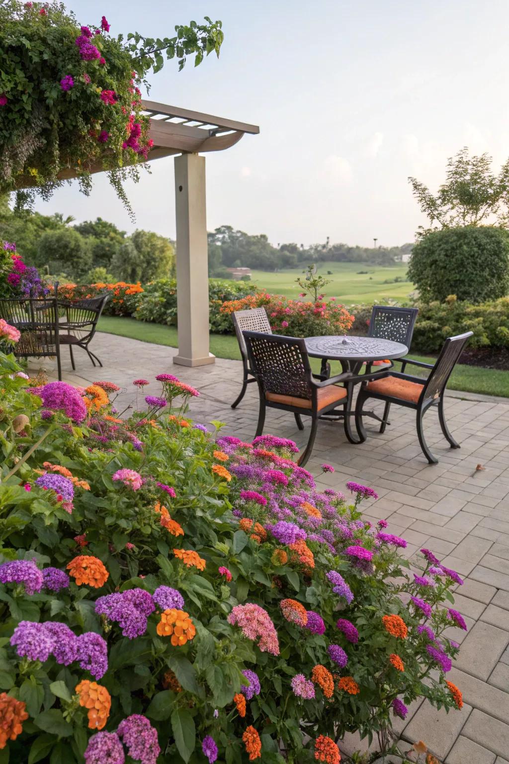 A cozy outdoor seating area framed by vibrant lantanas.