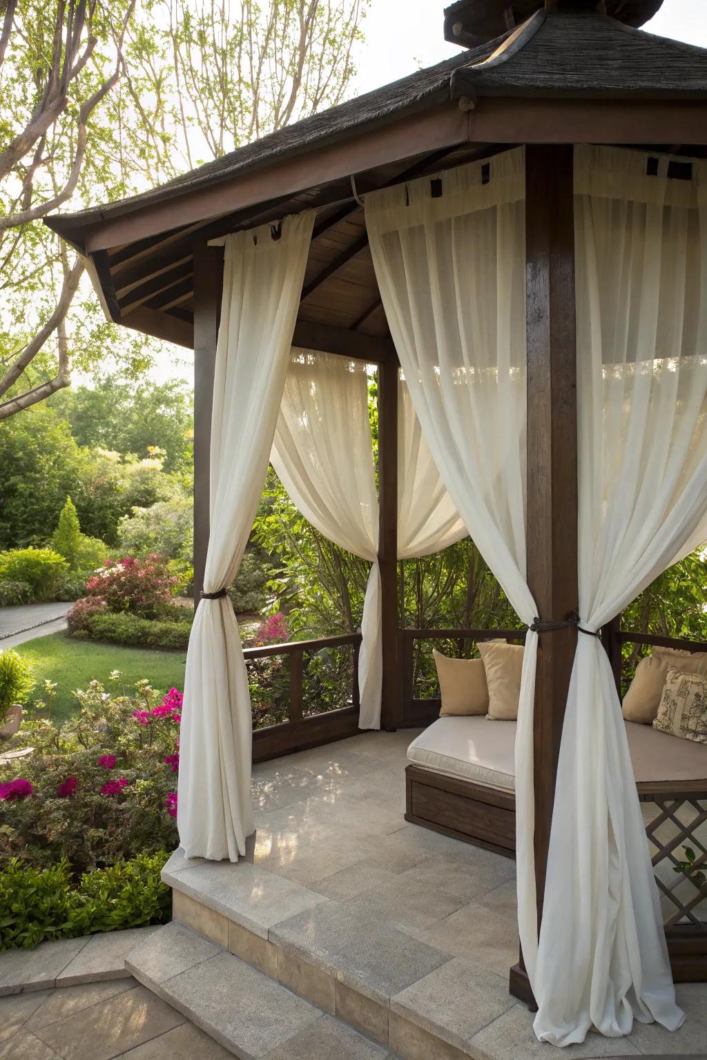 A pavilion transformed into a private retreat with curtains.