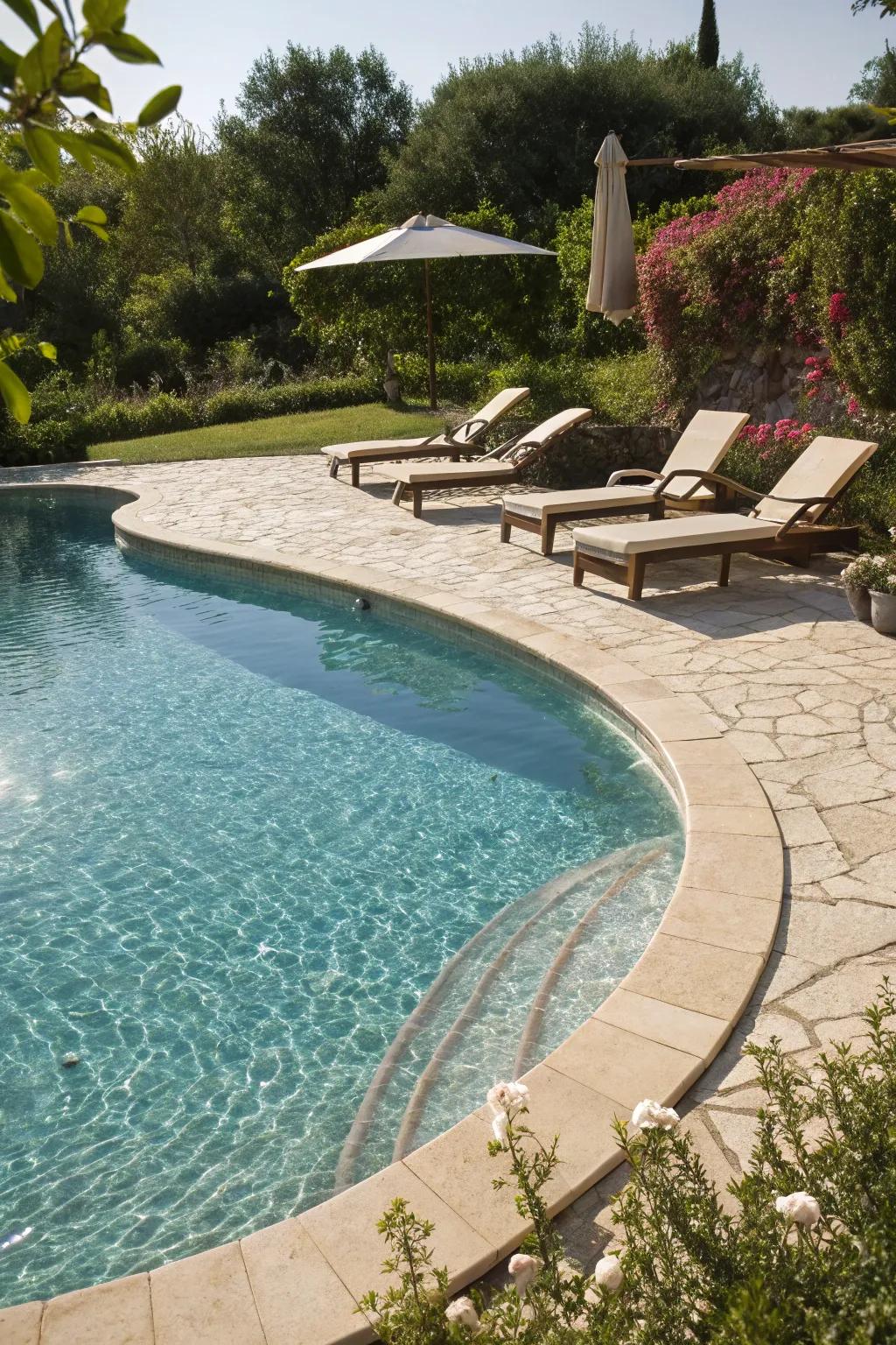 A tanning ledge provides a sunny spot for relaxation in this kidney pool.