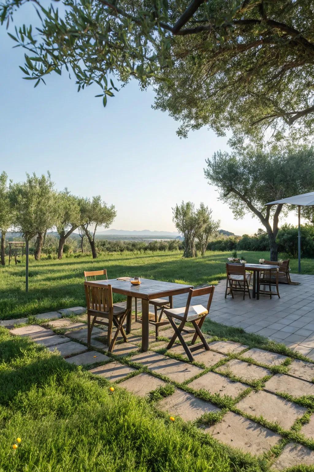 An outdoor dining area on pavers surrounded by grass offers a charming dining experience.