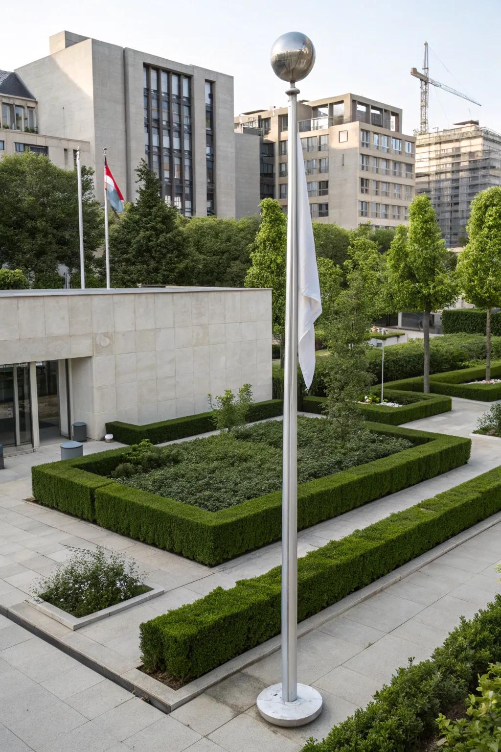 A minimalist sphere topper offers a sleek, modern touch to this flagpole.