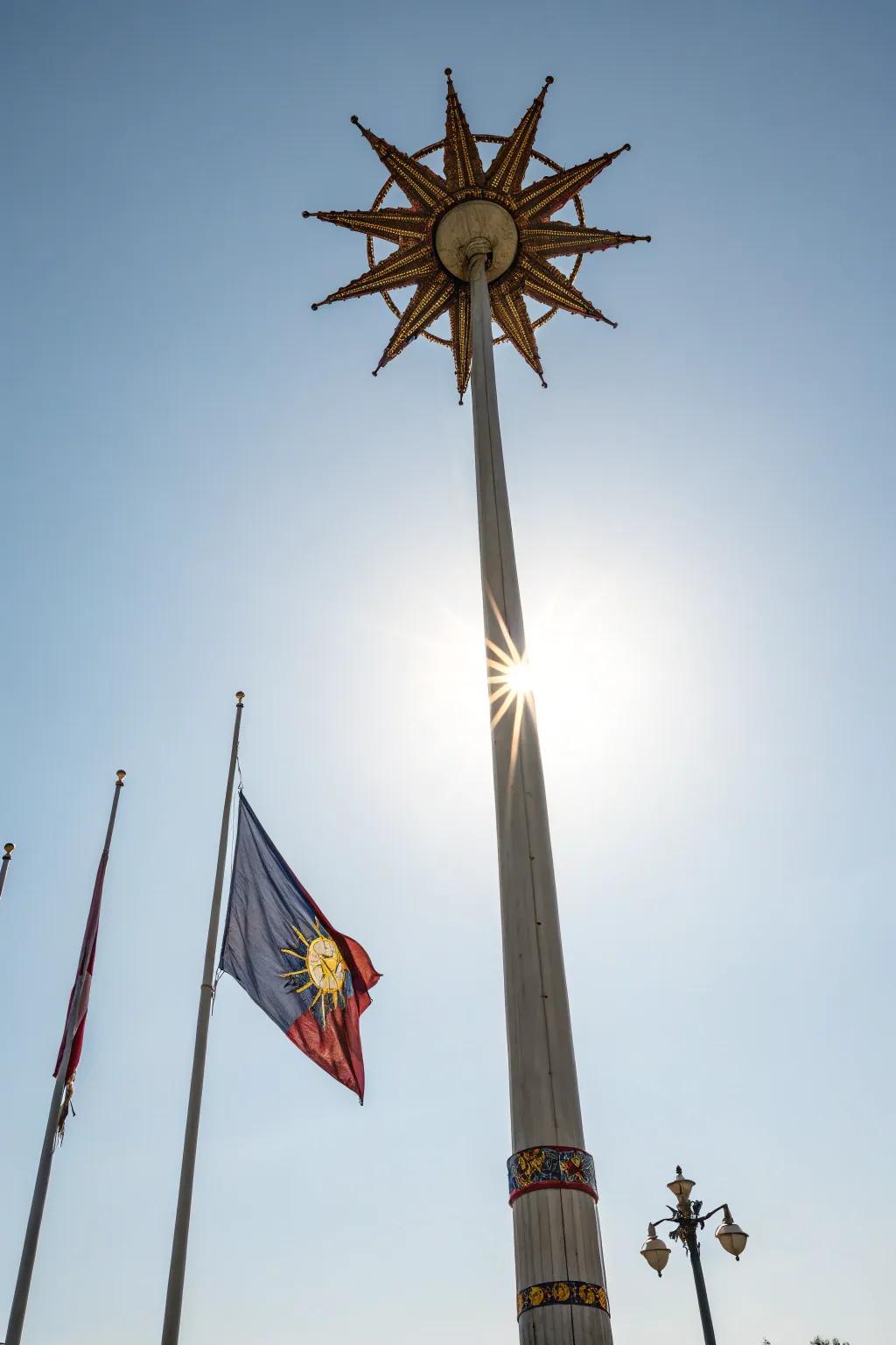 A sunburst design topper radiates cheer on this flagpole.