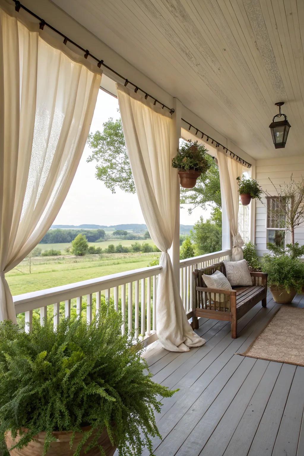 Elegant drapes adding softness to a farmhouse porch.