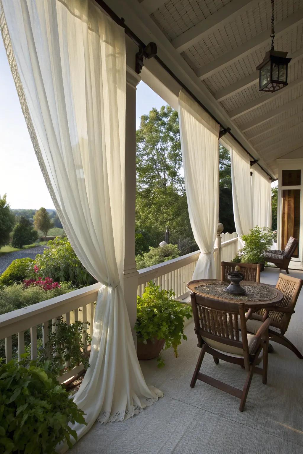 Porch with flowing outdoor curtains creating a private space.