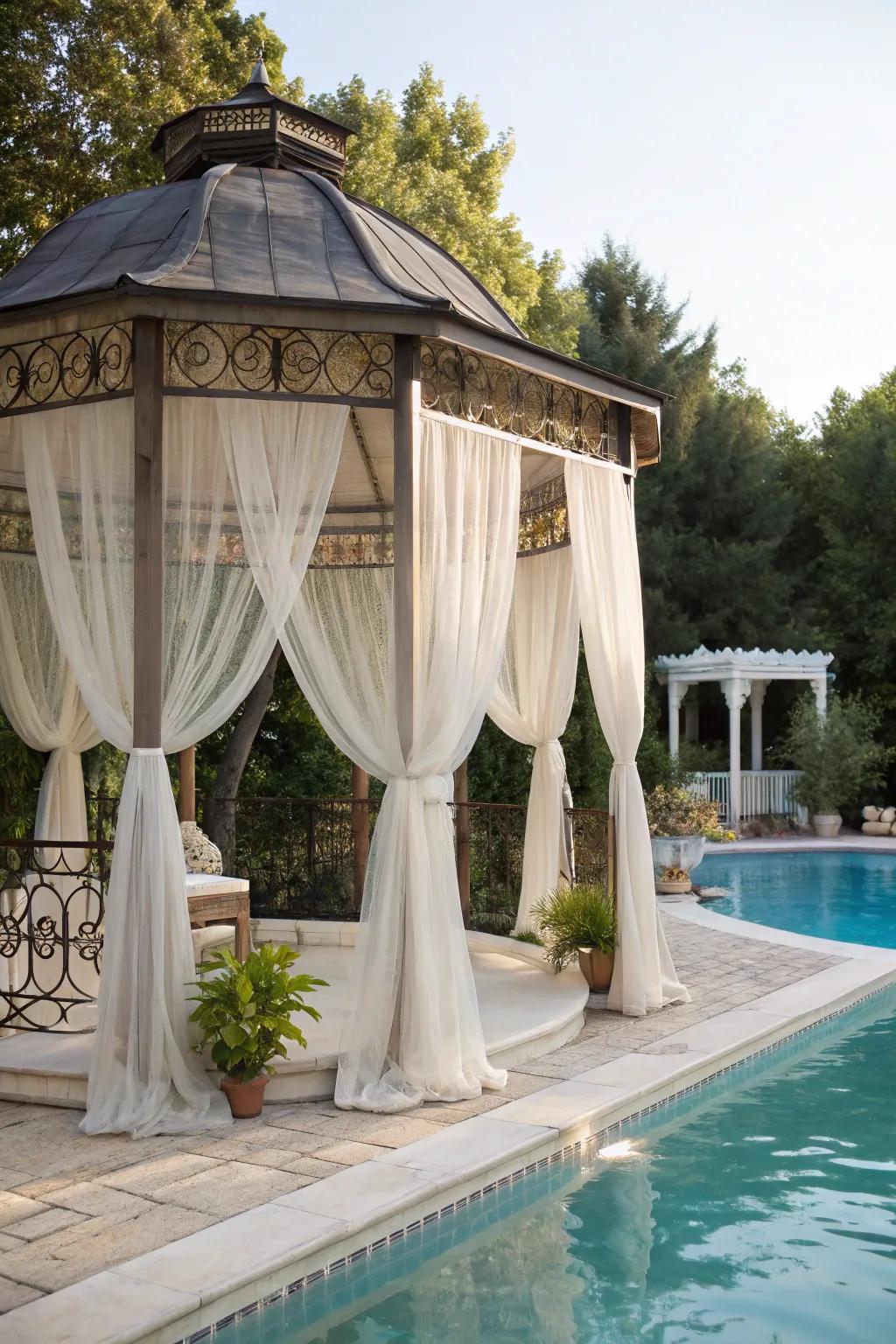 A romantic gazebo with sheer drapes adds a dreamy touch to the pool.