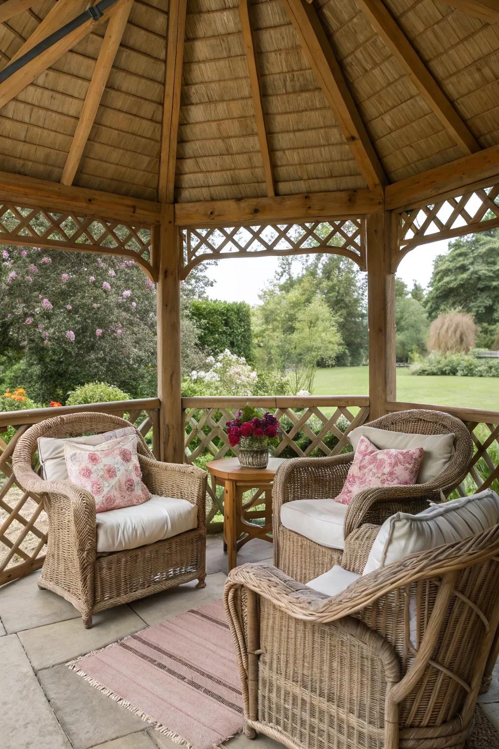 A cozy seating area with wicker chairs inside a rustic gazebo.