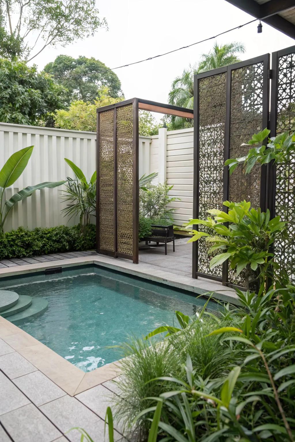 A small pool area with chic privacy screens for seclusion.