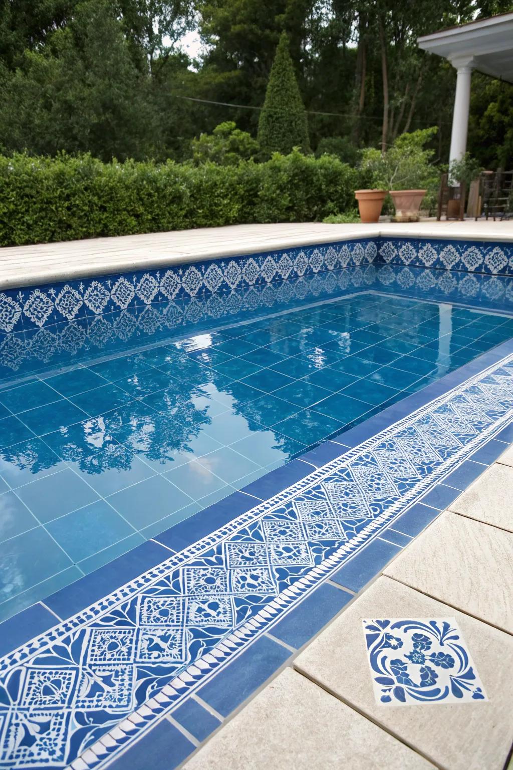 A serene pool adorned with classic blue porcelain tiles.