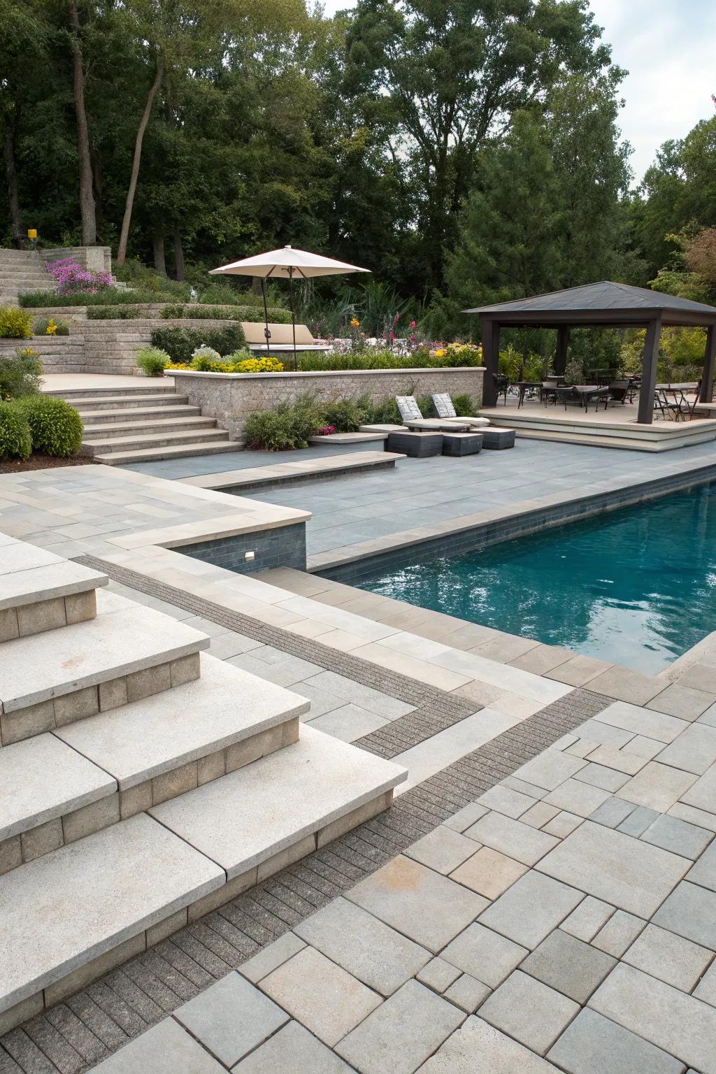 Elevated pool deck with dynamic multi-level paver design.