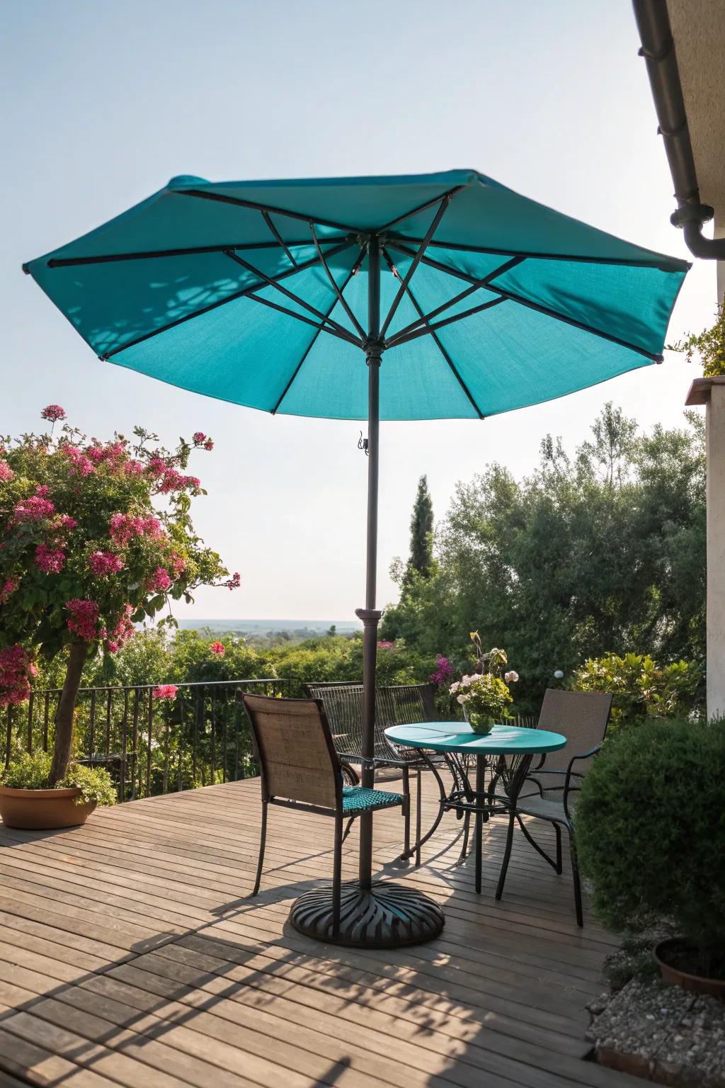 Patio with a bright teal umbrella providing shade.