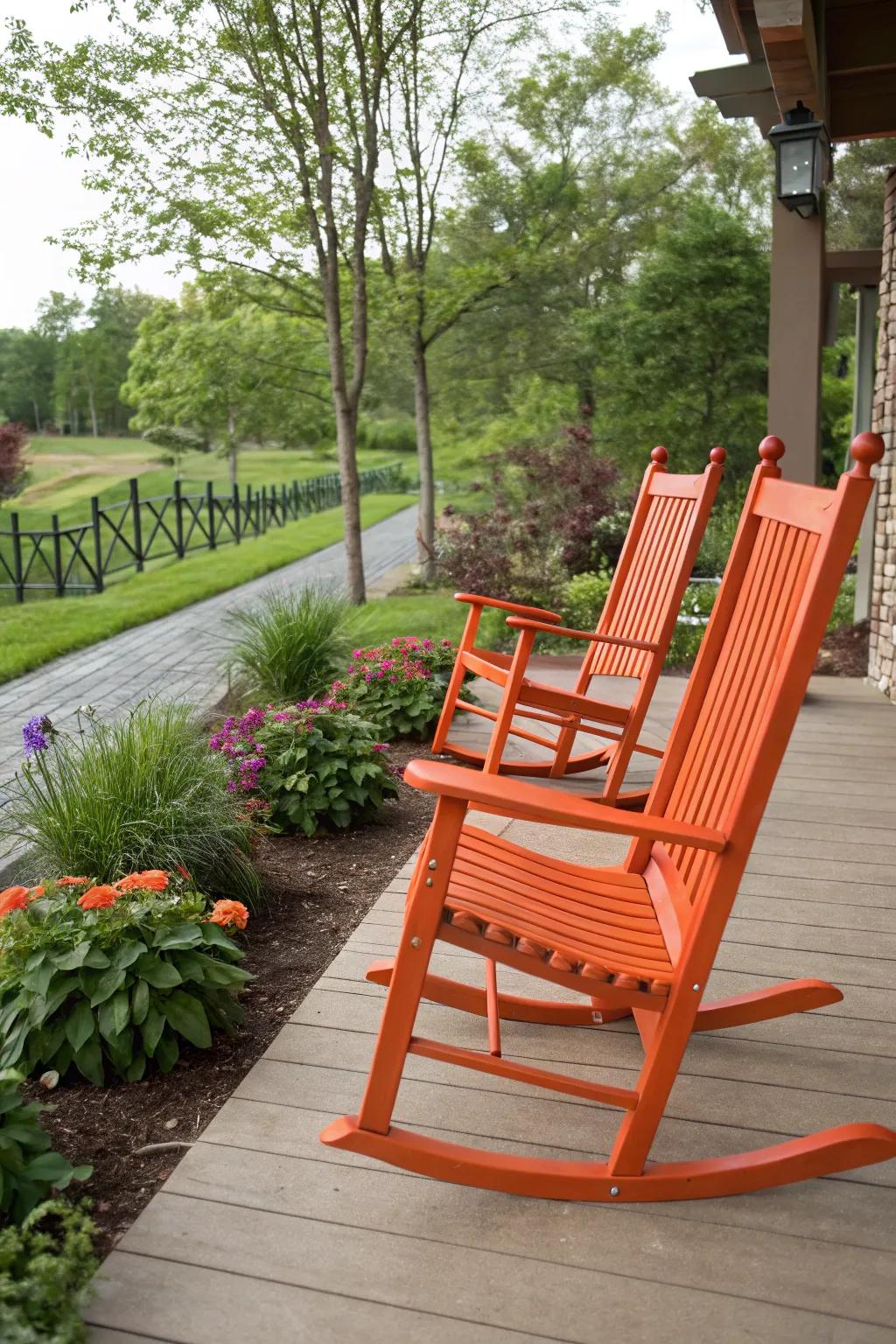 Patio with vibrant orange rocking chairs.