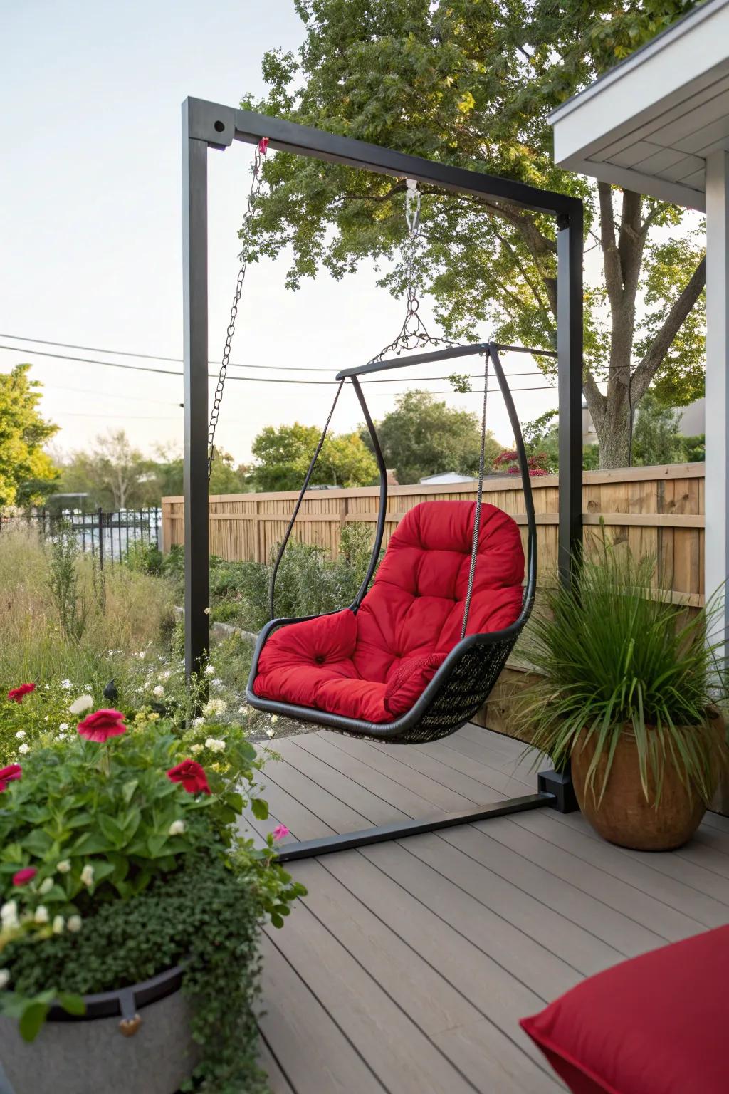 Patio with a bold red hanging chair.
