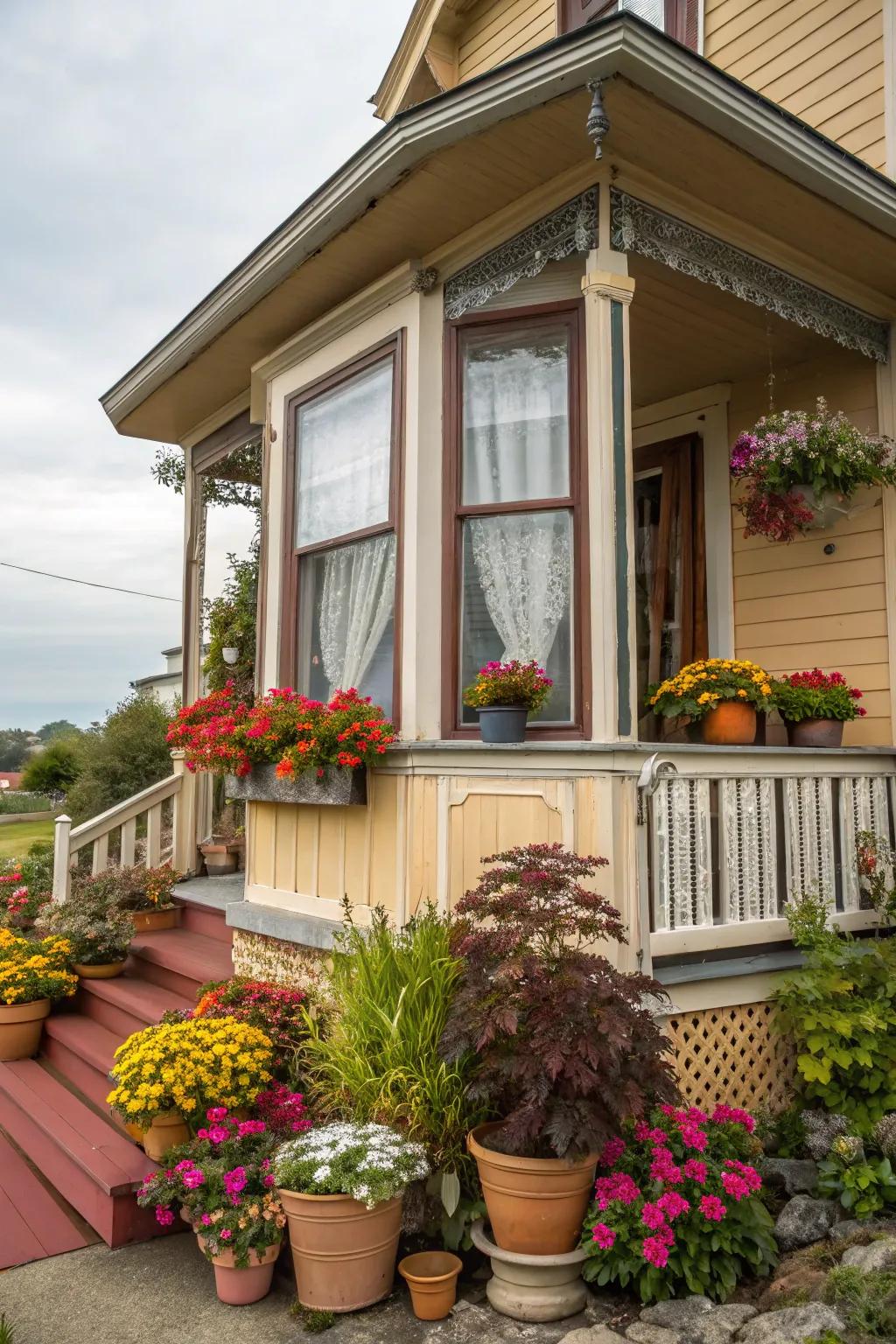 Vibrant potted plants bring color and charm to a front porch with a bay window.