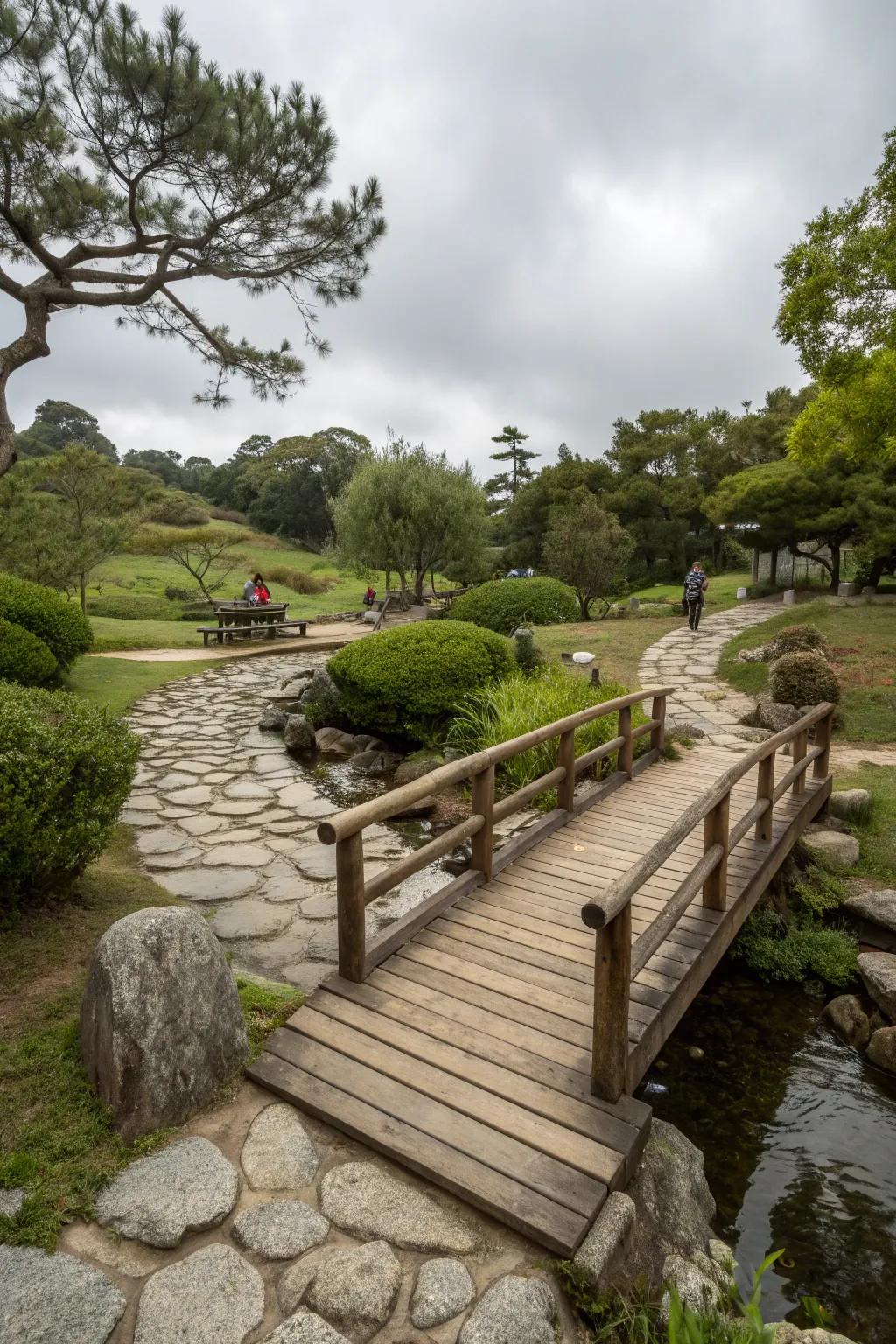 A small wooden bridge creating a whimsical touch in a meditation garden.