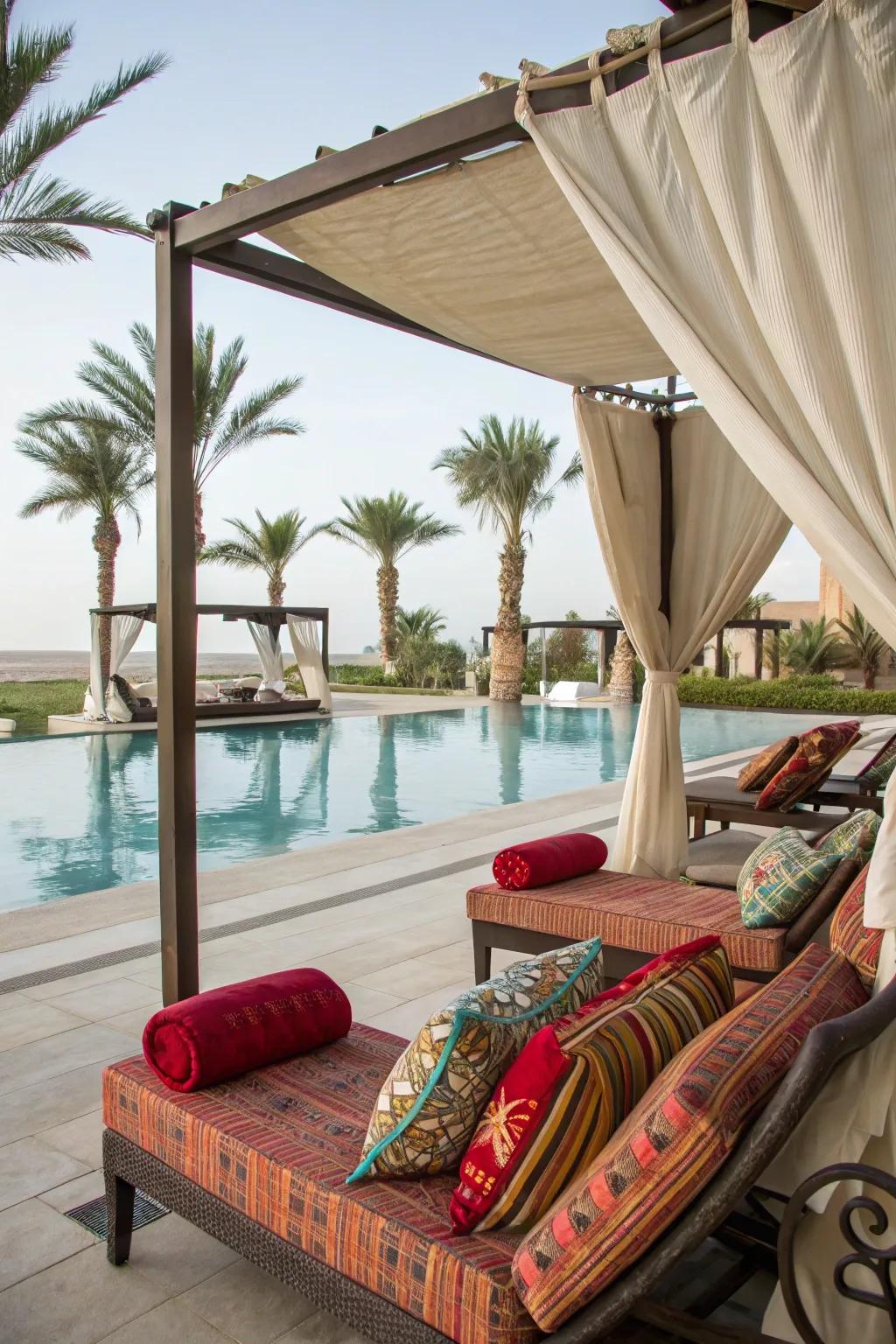 Create a cozy corner by the pool with plush lounges and pops of color.
