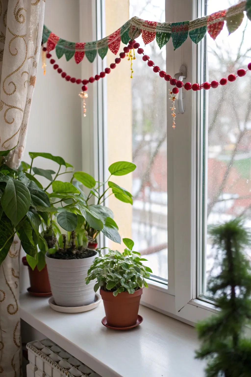 A window sill decorated with a garland and potted plants.