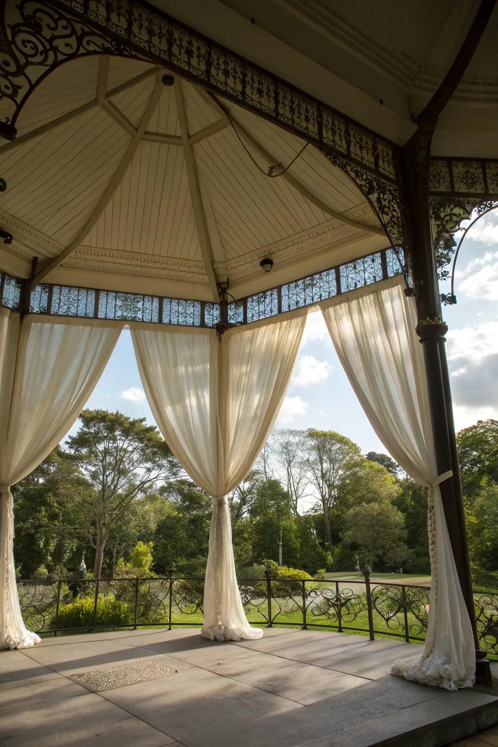 Fabric drapes add elegance and charm to the pavilion.