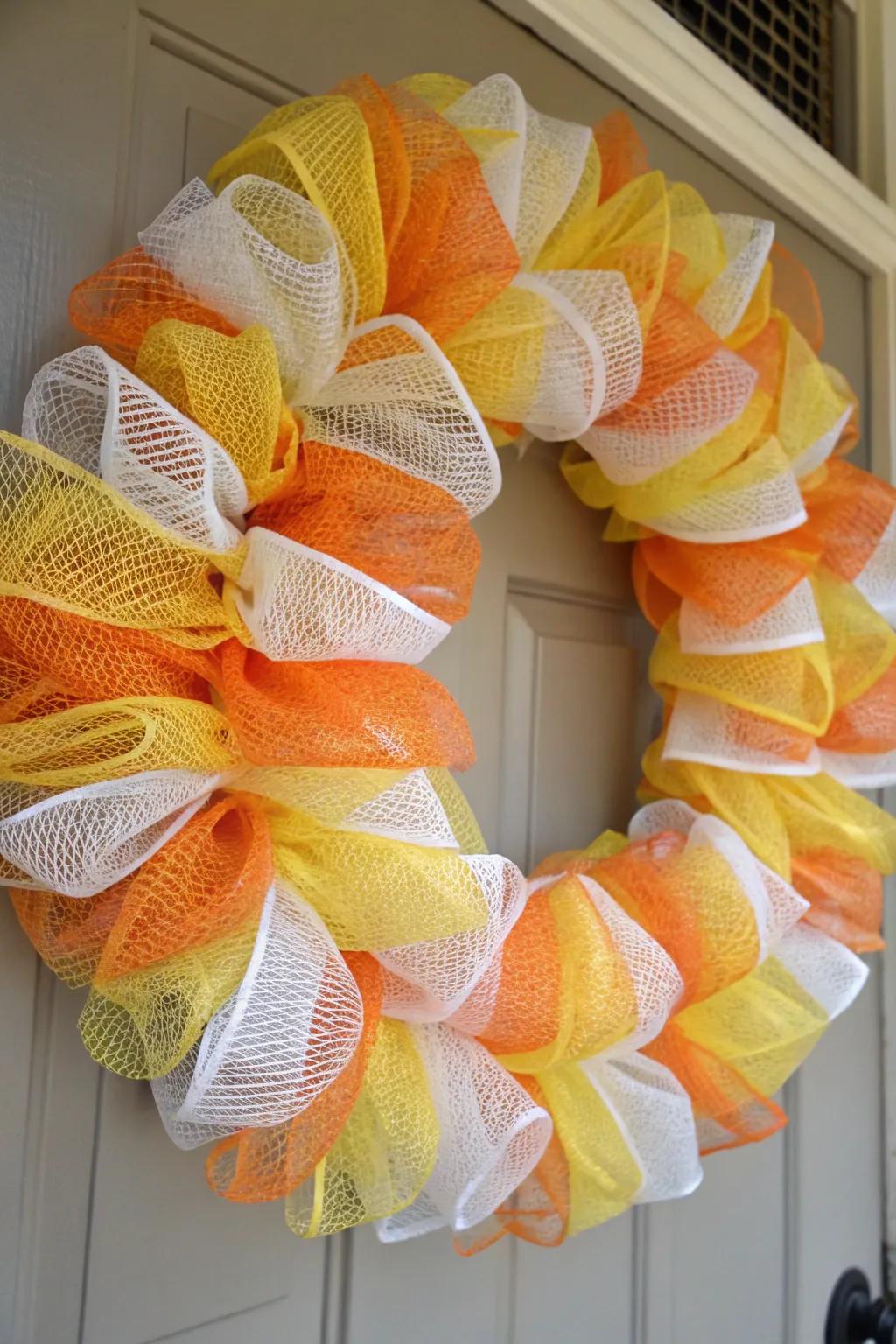 A candy corn wreath that adds a sweet touch to Halloween decor.