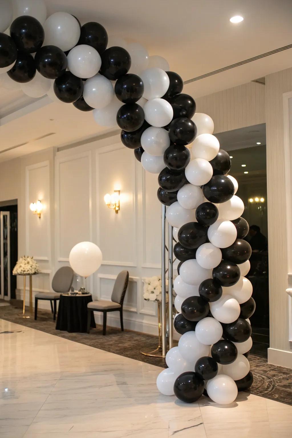 A bold and elegant black and white balloon arch.