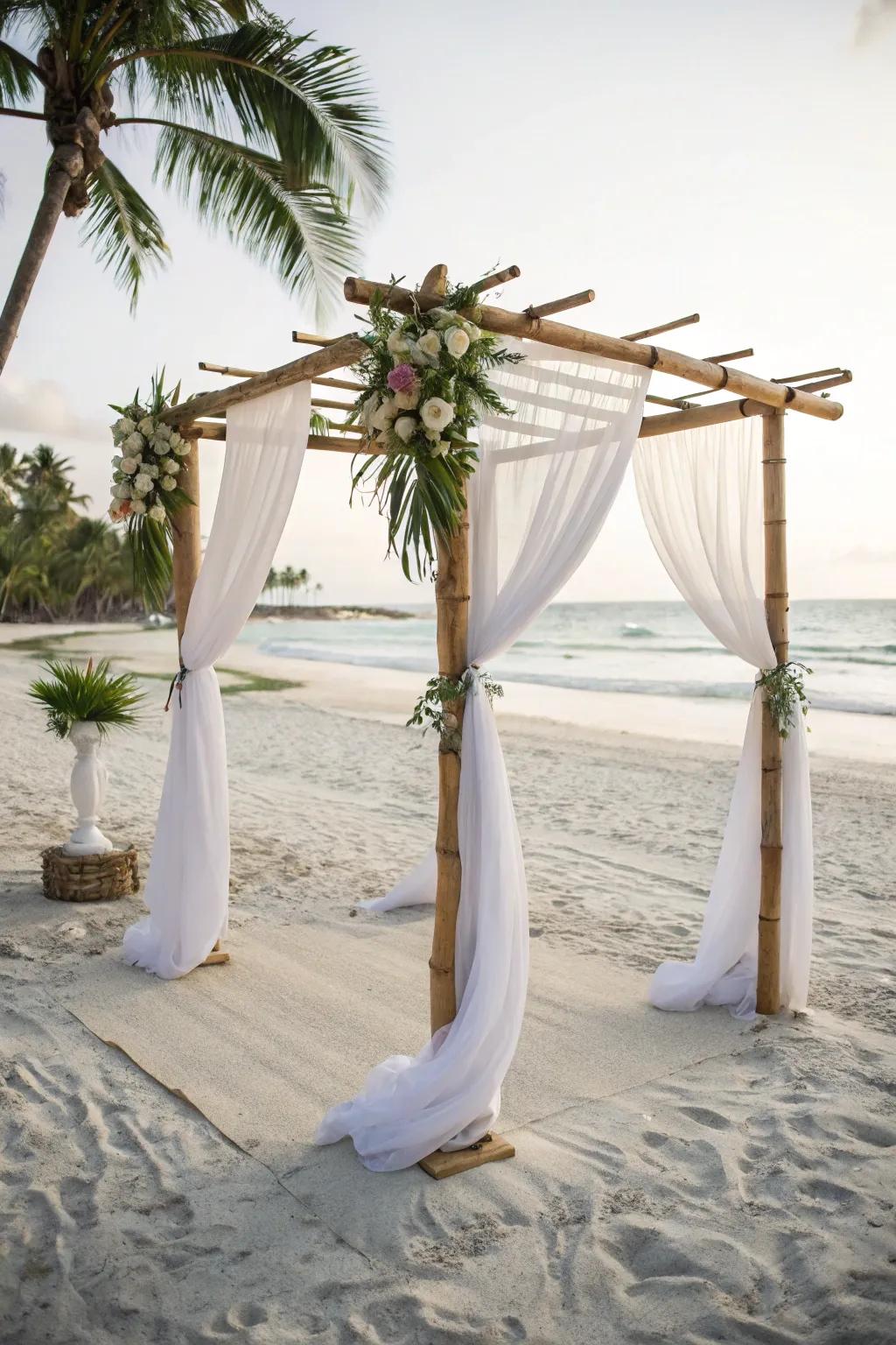 Bamboo structure with flowing fabric for a beach altar.