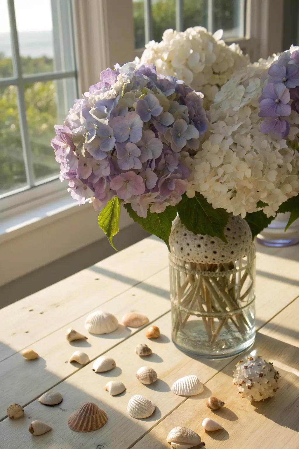A vibrant mix of hydrangeas and seashells creates a refreshing centerpiece.