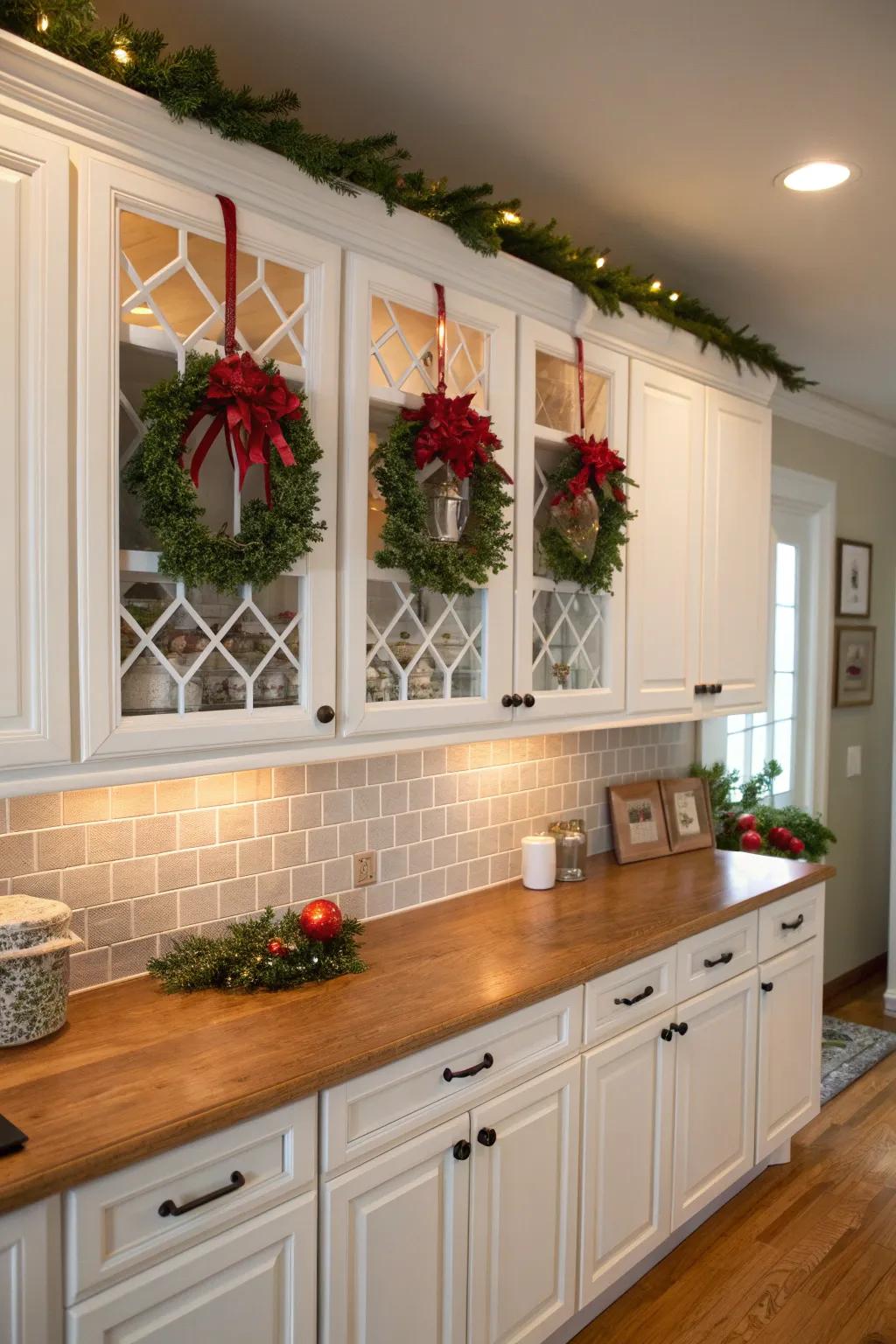 Mini wreaths on kitchen cabinets add a festive and unexpected touch.