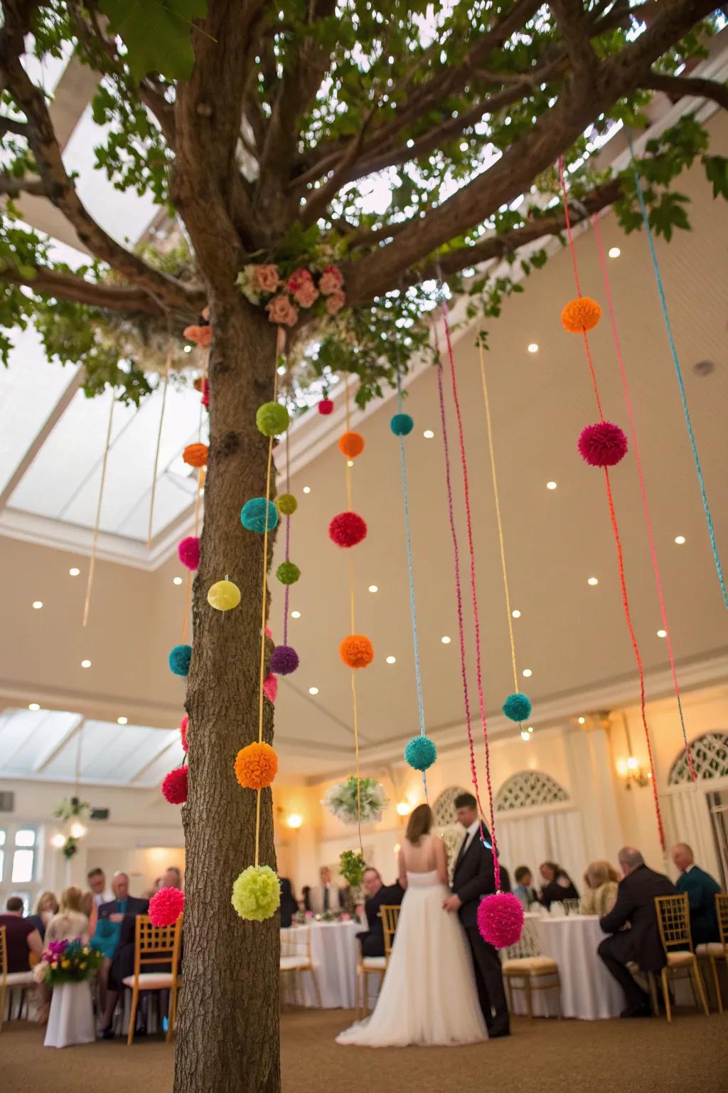 Pom-pom strings add a playful vibe to this wedding tree.