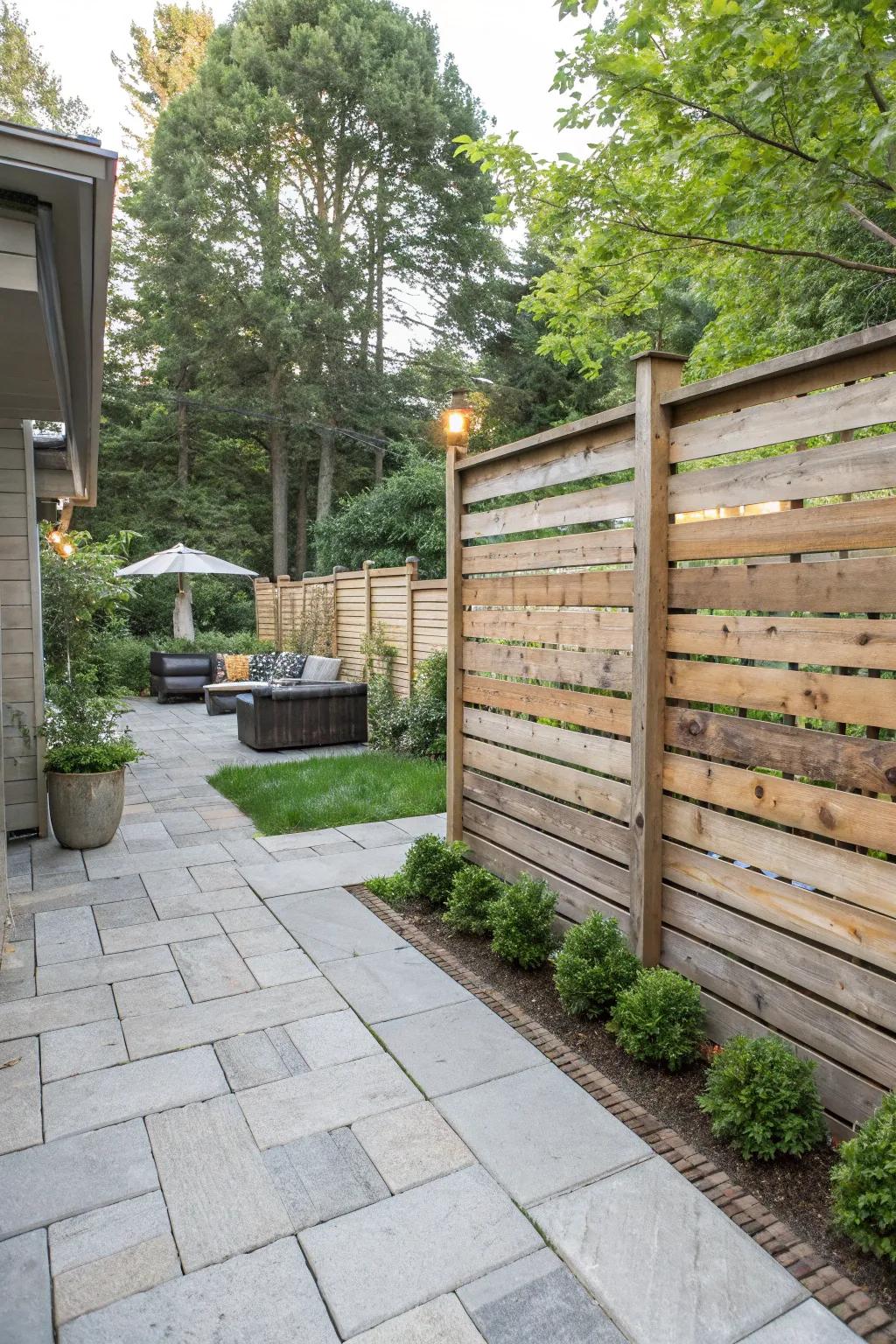 A sleek horizontal plank fence in a stylish backyard.