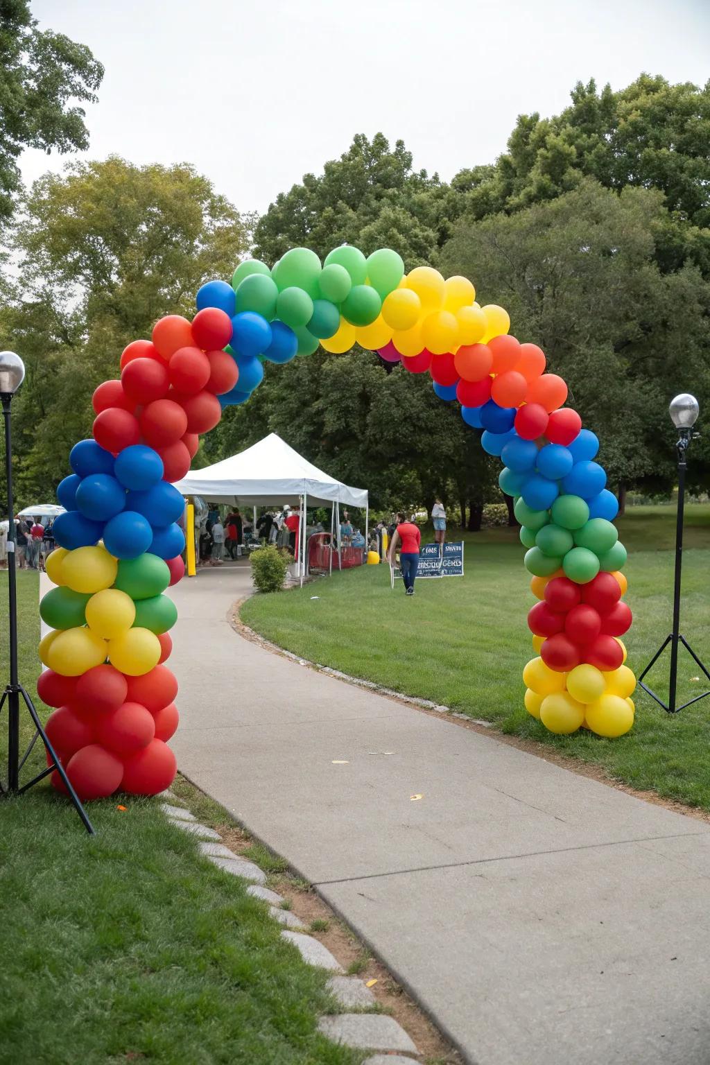 A vibrant balloon arch announces the festivities at a park gathering.