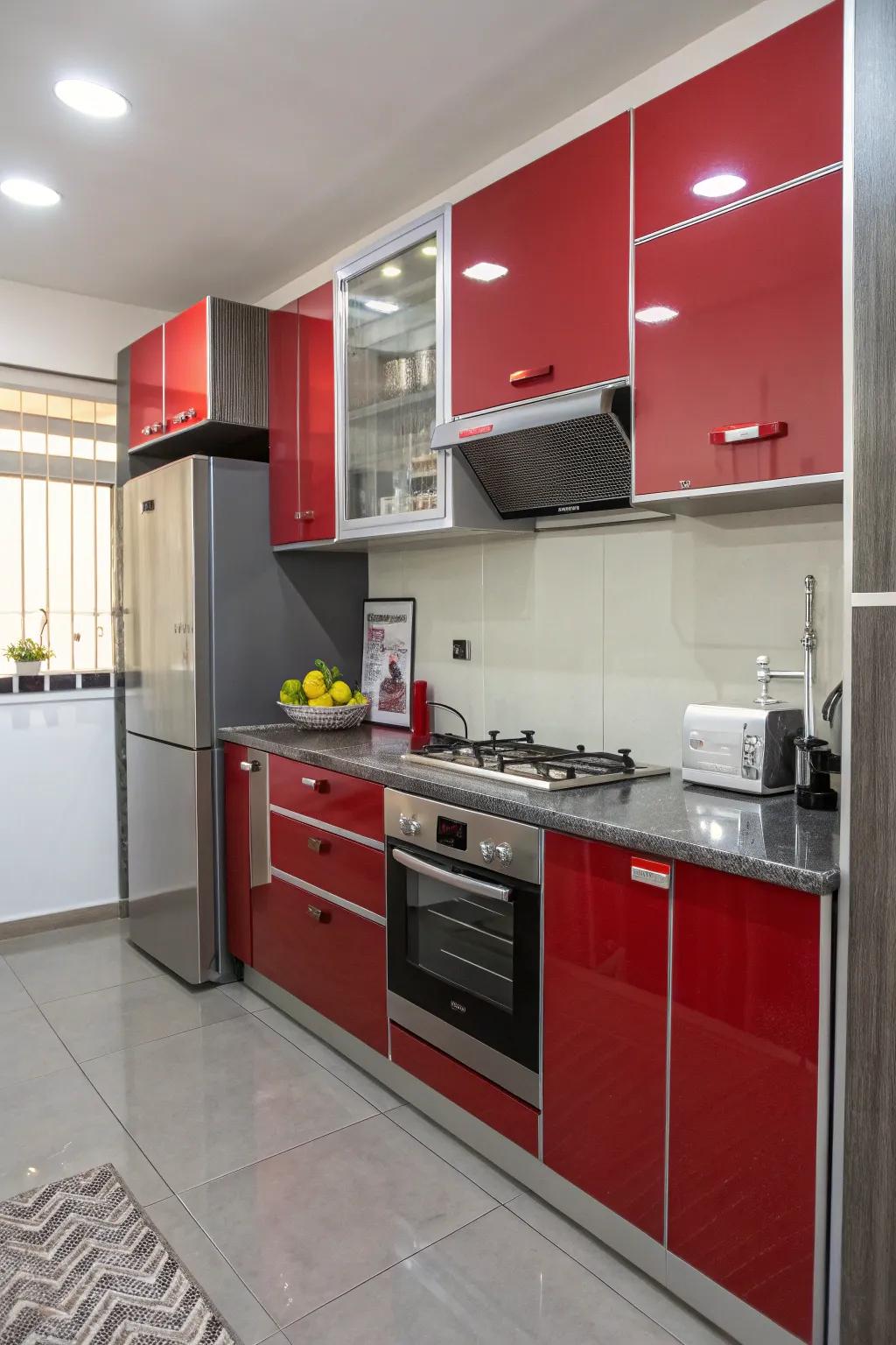 Shiny red and grey cabinets reflecting light, enhancing a small kitchen’s sense of space.
