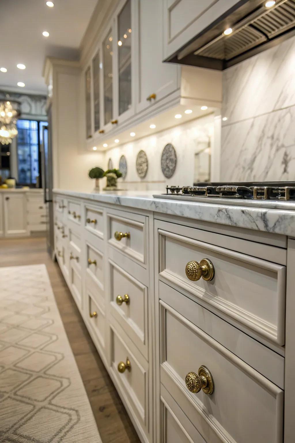 Marble knobs add a sophisticated touch to luxurious kitchen cabinets.