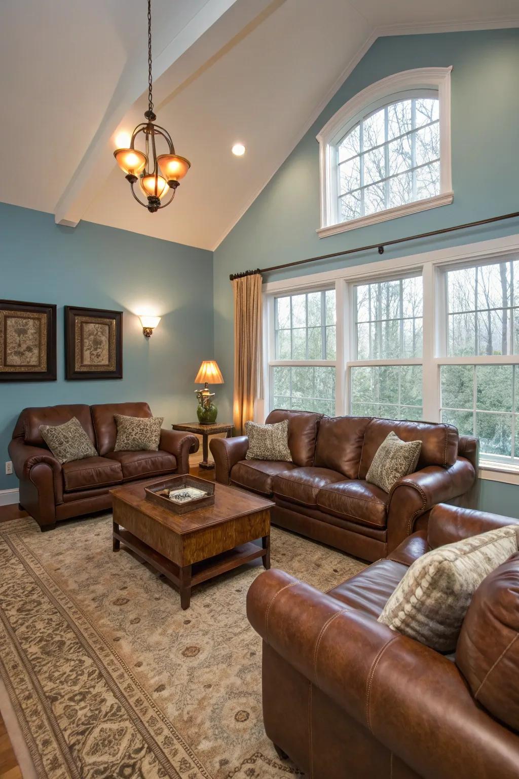 Sky blue walls and brown leather furniture create a serene living room.