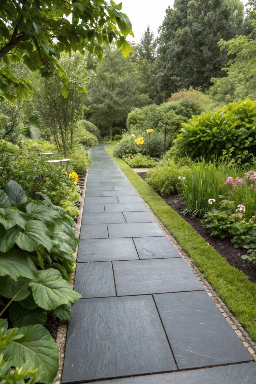 A sophisticated basalt walkway offering a striking contrast in a garden setting.