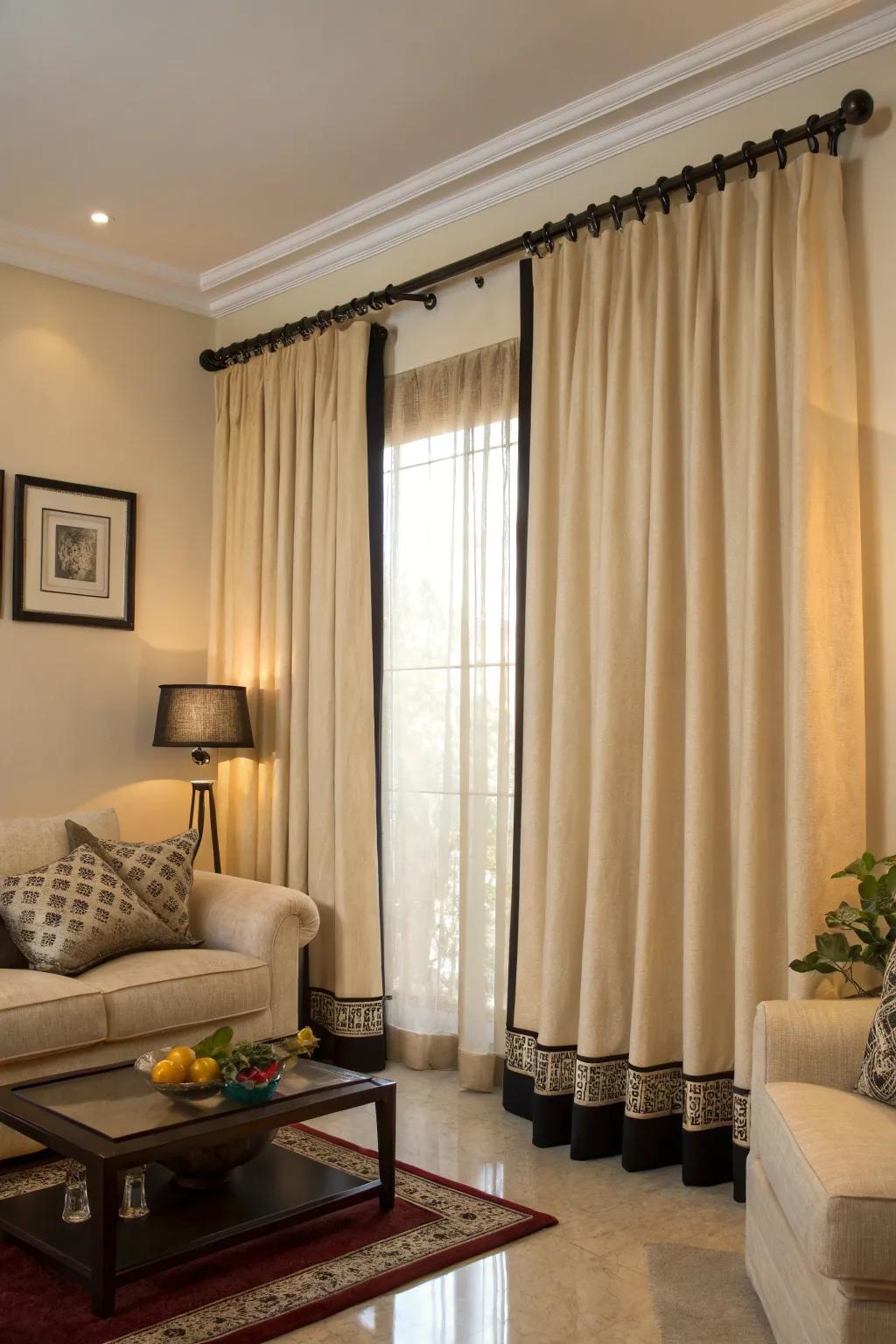 Black trim adds a refined touch to beige curtains in this living room.